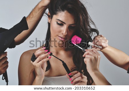 Beautiful young woman getting her hair and make up done, beauty concept, studio shot