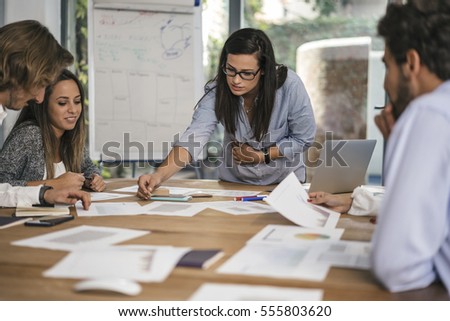 Creative people doing a brainstorming meeting in a modern studio