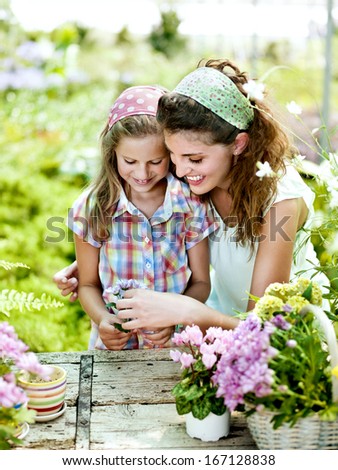 Mom And Daughter Have Fun In The Work Of Gardening