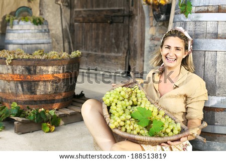 woman showing basket of grapes already picked up