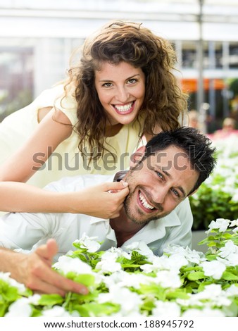 couple have fun choosing flower in a greenhouse