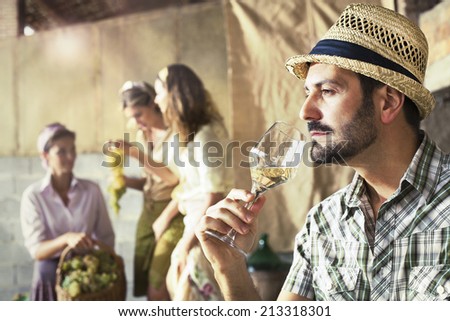 farmer taste a glass of white wine