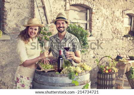 farmers couple drinking wine in a farm