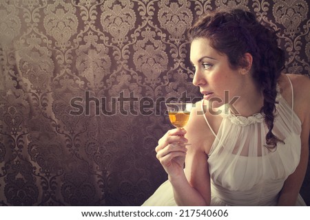 dreaming woman drinks a glass of excellent Scotch whisky