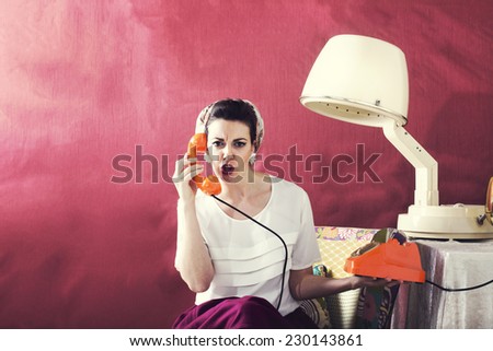 Vintage angry housewife chats on the phone in Hair salon