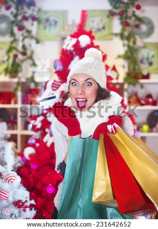 crazy woman with her credit card and christmas gifts