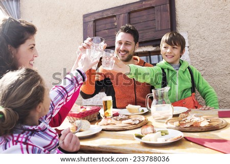 family cheers in a mountain chalet