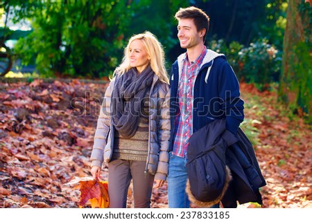 couple walking in a park in autumn