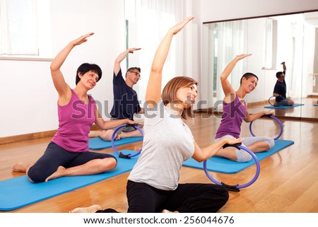 group of people copying fitness exercise by the teacher