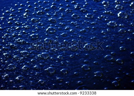 Water with blue bubbles as a texture or background or representing a carbonated drink. / Carbonated Drink
