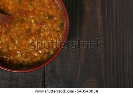red lentil soup close-up on the wooden table horizontal top view close up