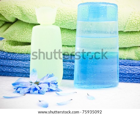 grouping of lotion bottles with blue flower