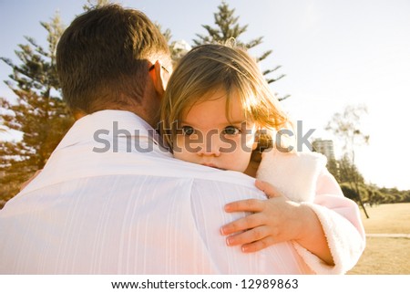 Father and Daughter hugging at the beach