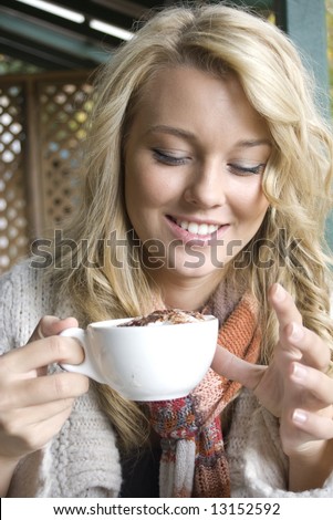 young girl at a cafe drinking coffee