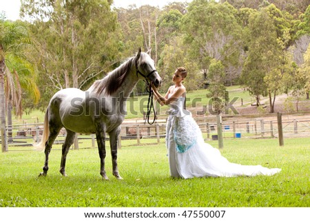 stock photo beautiful young woman with a grey horse in the country