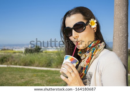 Young girl drinking soda with a straw