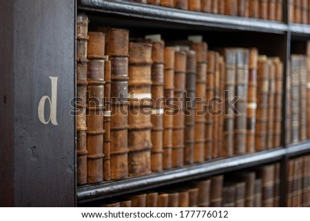Dublin, Ireland - January 03, 2014: Shelves in The Long Room in Trinity College Library. Measured at almost 65 metres (213 ft) long and It is the permanent home to the famous Book of Kells.