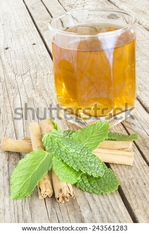 Close-up of a cup of tea with cinnamon and peppermint