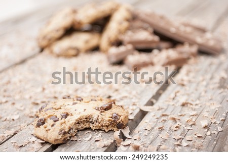 Bitten homemade chocolate chip cookies on wooden background