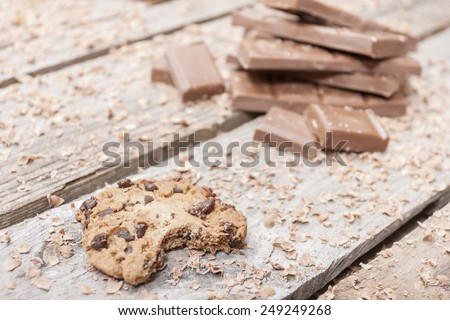 Bitten homemade chocolate chip cookies on wooden background
