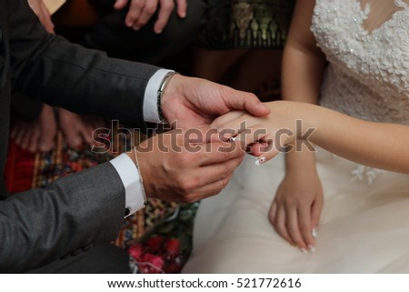 Groom put the wedding ring on bride\'s finger. Concept of marriage.