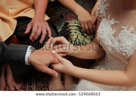 Bride put the wedding ring on groom\'s finger. Concept of marriage.