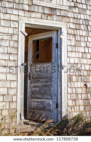 The door on an old home standing ajar