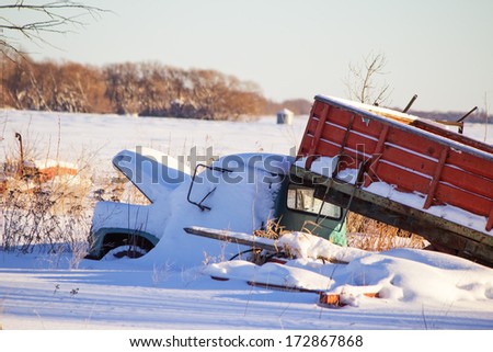 An old grain truck covered in snow