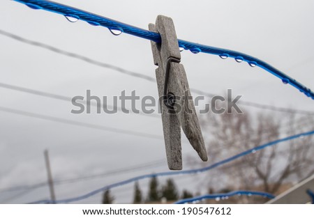 Clothes pin on a wet clothes line
