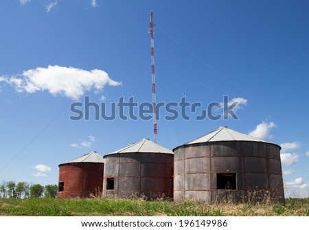 Old grain bins in front of communications tower