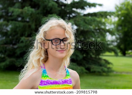 Young blonde girl wearing black rimmed glasses