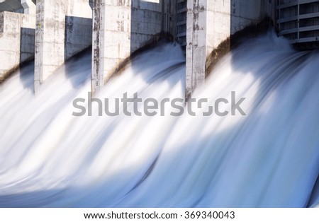 Water rushing out of open gates of a hydro electric power station in long exposure