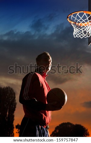 Basketball player silhouette at sunset