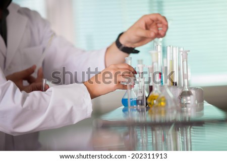 Young scientist works in modern chemistry lab