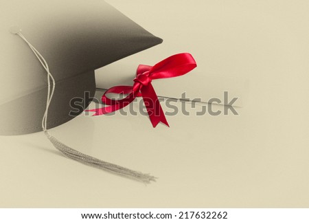 Graduation cap and diploma. Old Scroll paper