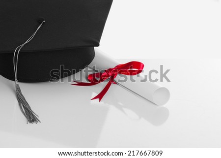 Black Graduation Cap with Degree Isolated on White Background