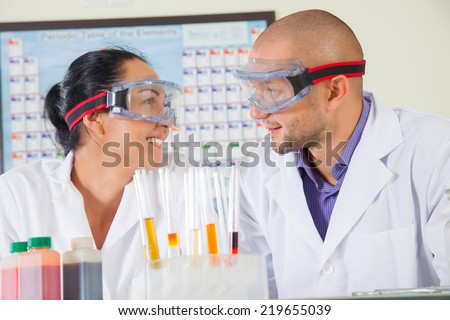Attractive young female scientist and her male supervisor in the life science research laboratory (biochemistry, genetics, forensics, microbiology..)