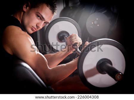 man with weight training equipment on sport gym club- fitness