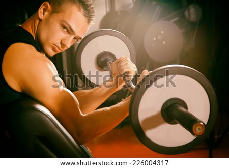 man with weight training equipment on sport gym club- fitness