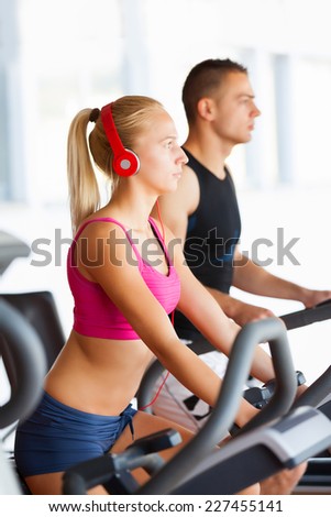 group of women and men - doing sport Spinning in the gym for fitness