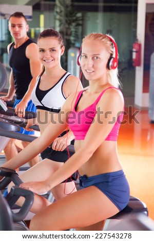 group of women and men - doing sport Spinning in the gym for fitness