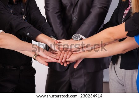 Team work concept. Business people joining hands in office.