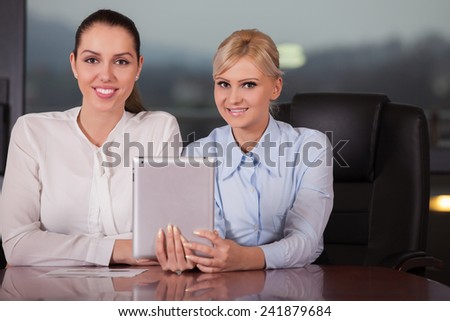 Businesswomen Meeting Around Table In Modern Office