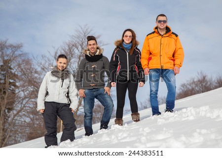 happy young beautiful people group have fun and enjoy fresh snow at beautiful winter day