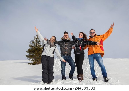 happy young beautiful people group have fun and enjoy fresh snow at beautiful winter day