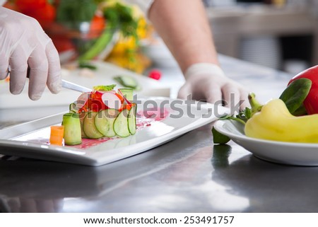 mature chef preparing a meal with various fruits and vegetables