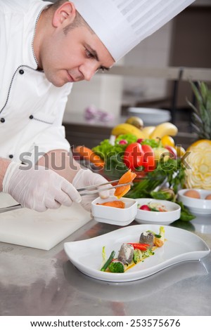 mature chef preparing a meal with various vegetables