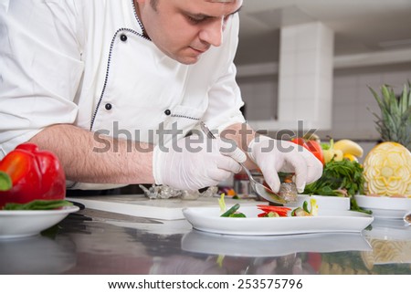 mature chef preparing a meal with various vegetables