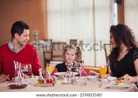 Waiter serving a family in a restaurant