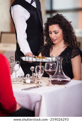 Waiter serving food in a restaurant